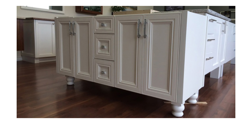 white cabinet with carved legs
